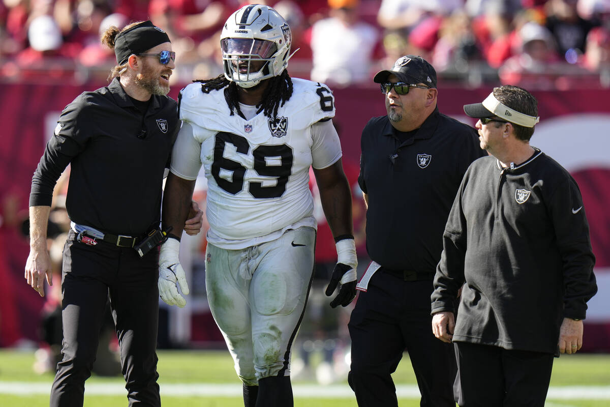 Las Vegas Raiders defensive tackle Adam Butler (69) walks off the field after injuryagainst the ...