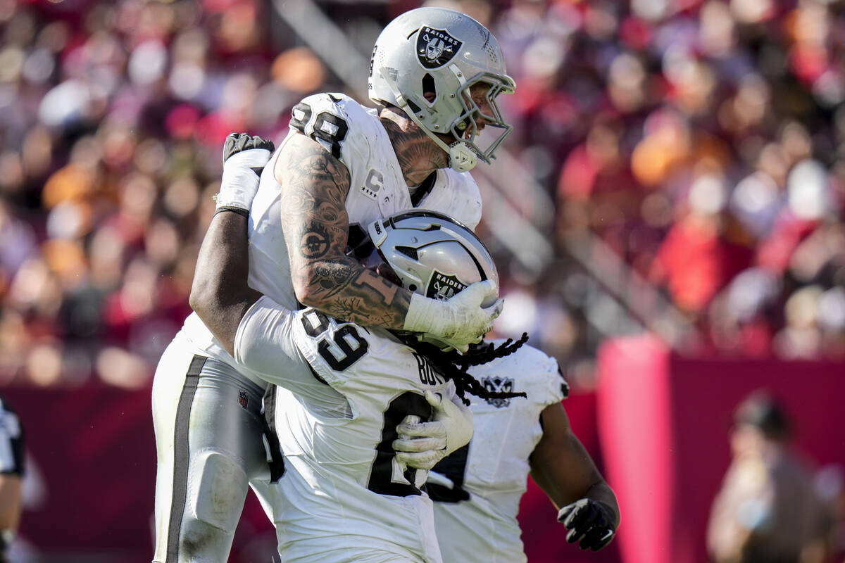 Las Vegas Raiders defensive tackle Adam Butler (69) celebrates with defensive end Maxx Crosby ( ...