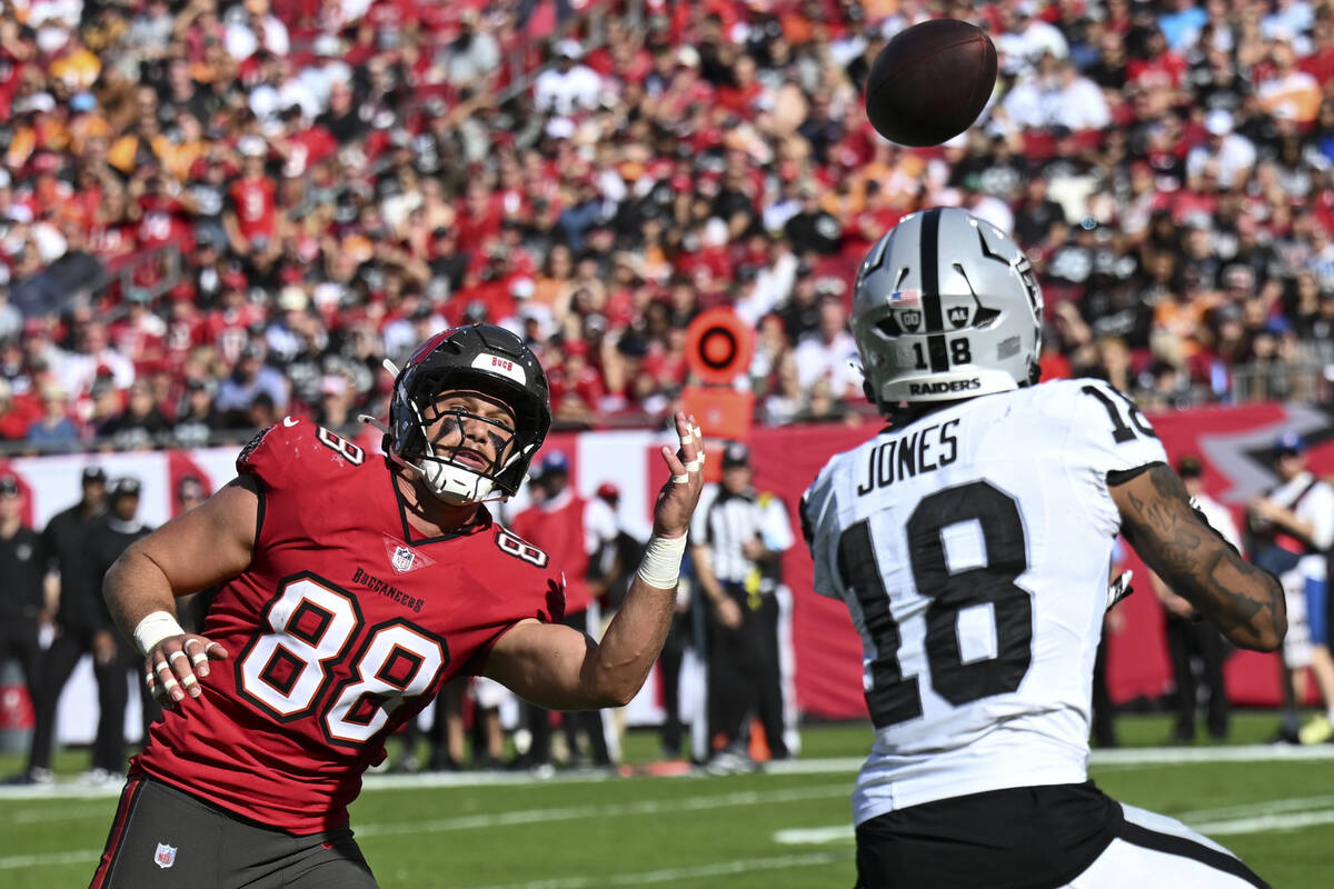 Las Vegas Raiders cornerback Jack Jones (18) prepares to intercept the ball from Tampa Bay Bucc ...