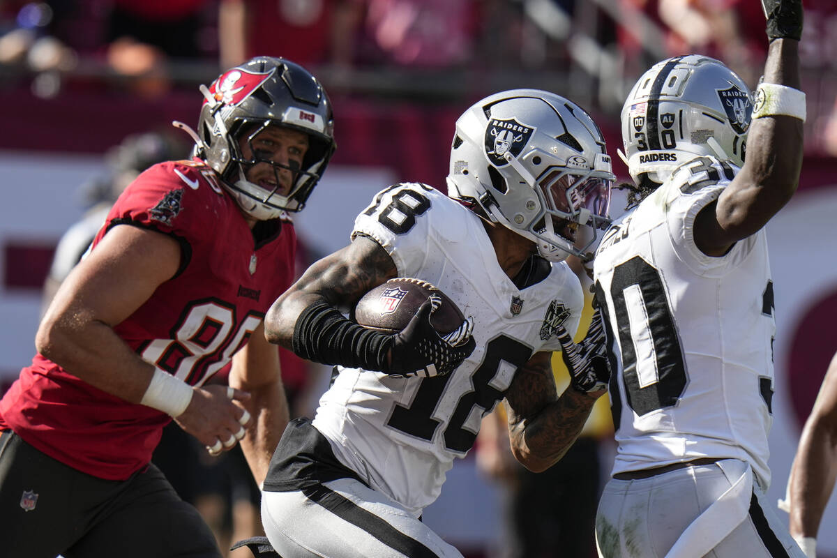 Las Vegas Raiders cornerback Jack Jones (18) runs the ball after interception against the Tampa ...