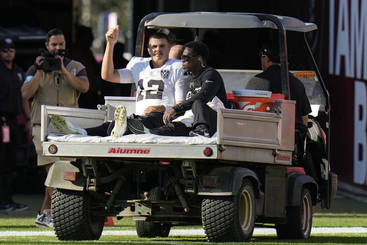 Las Vegas Raiders quarterback Aidan O'Connell (12) is taken off the field after an injury again ...