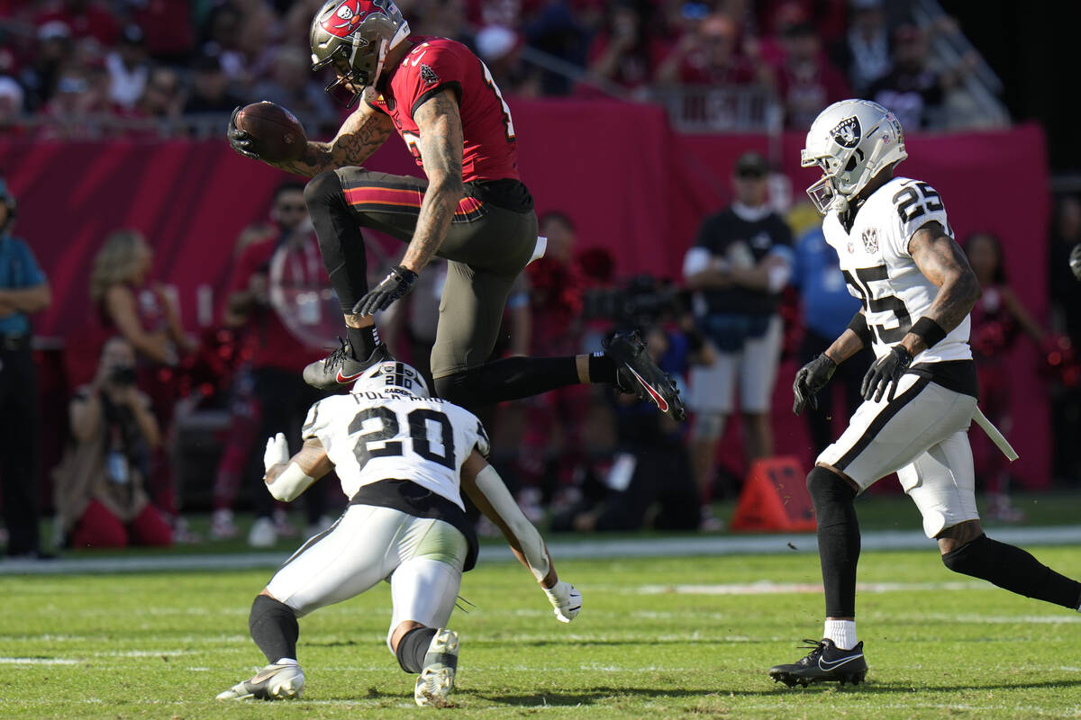 Tampa Bay Buccaneers wide receiver Mike Evans (13) leaps over Las Vegas Raiders safety Isaiah P ...