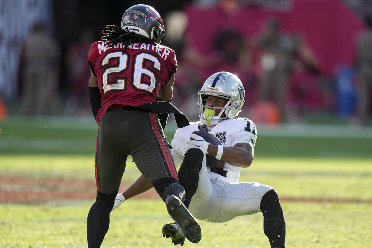 Tampa Bay Buccaneers safety Kaevon Merriweather (26) hits Las Vegas Raiders wide receiver Tre T ...