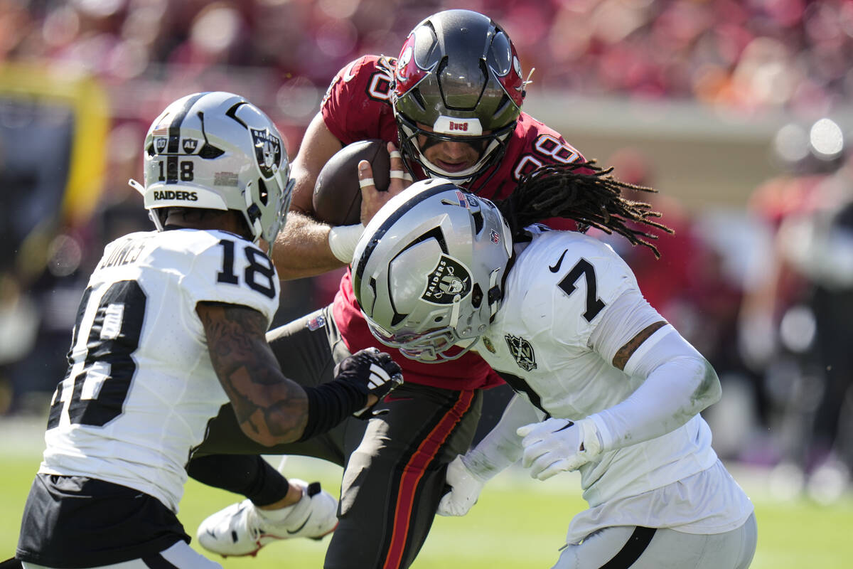 Las Vegas Raiders safety Tre'von Moehrig (7) and cornerback Jack Jones (18) hits Tampa Bay Bucc ...