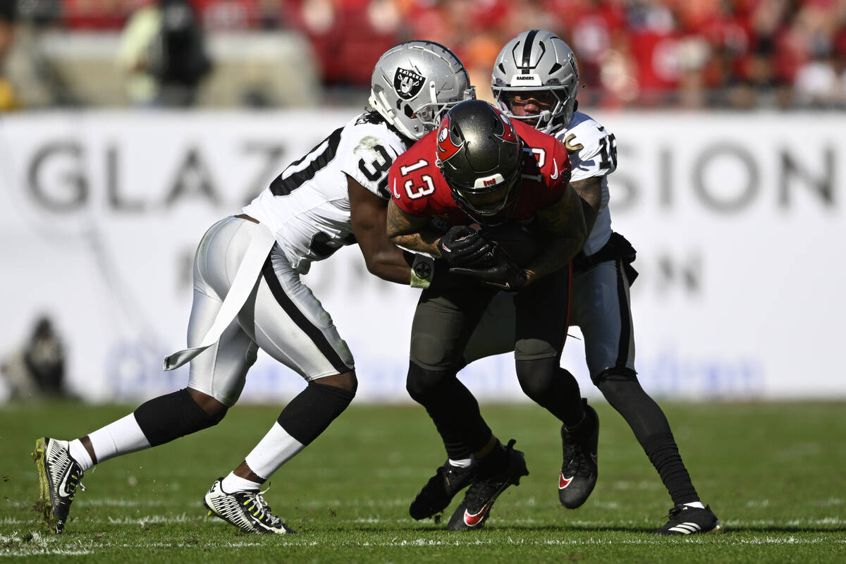 Tampa Bay Buccaneers wide receiver Mike Evans (13) is tackled by Las Vegas Raiders cornerback D ...