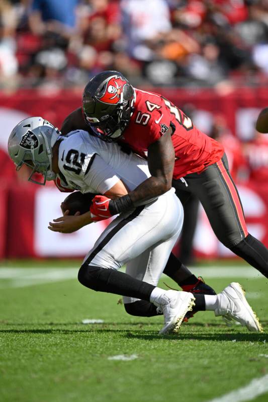 Las Vegas Raiders quarterback Aidan O'Connell (12) is sacked by Tampa Bay Buccaneers linebacker ...