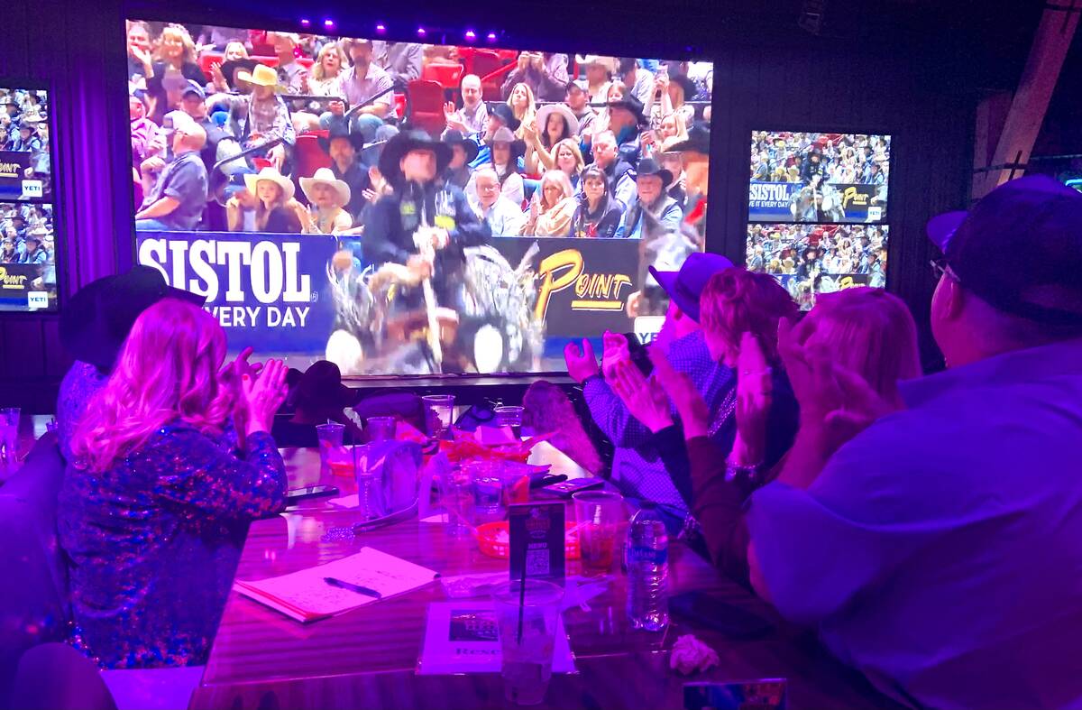 A group from the Tarleton State University Alumni Association applauds a winning score while wa ...