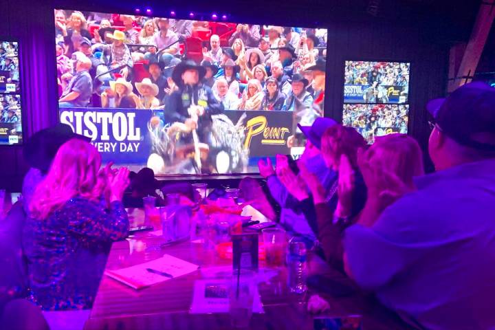 A group from the Tarleton State University Alumni Association applauds a winning score while wa ...