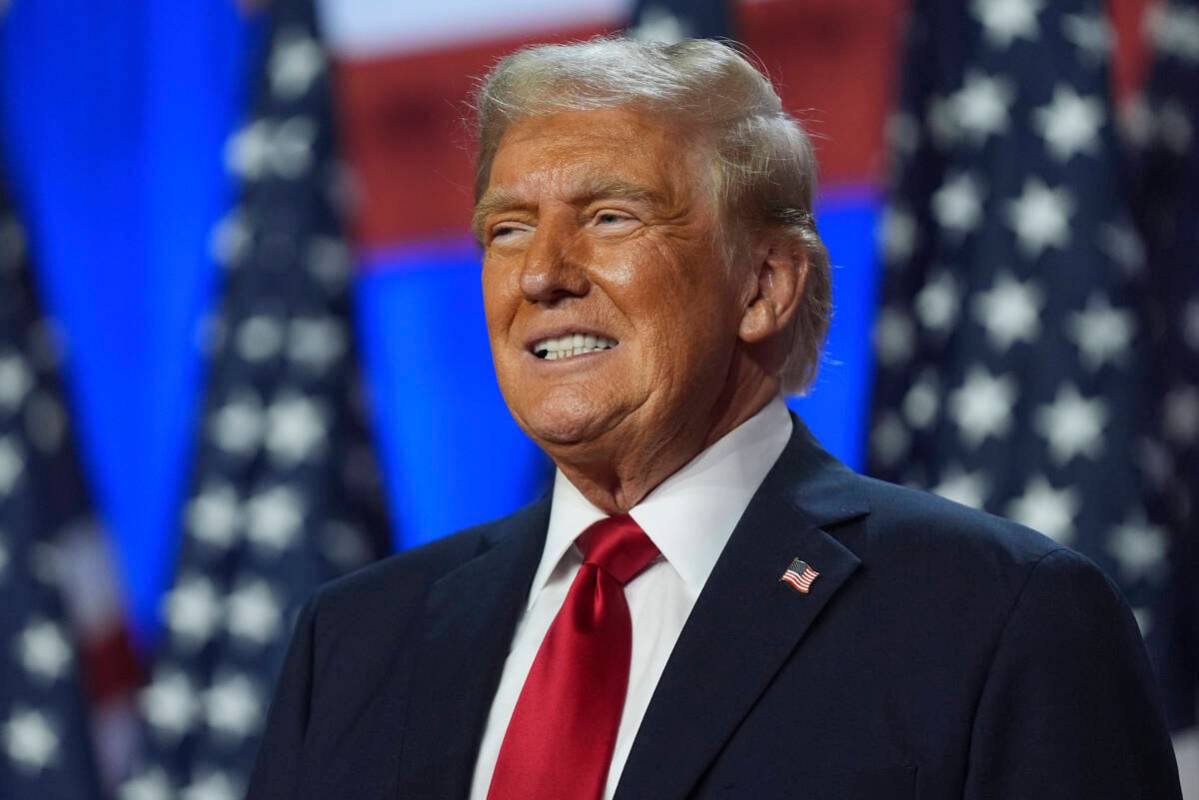 FILE - Republican presidential nominee former President Donald Trump smiles at an election nigh ...