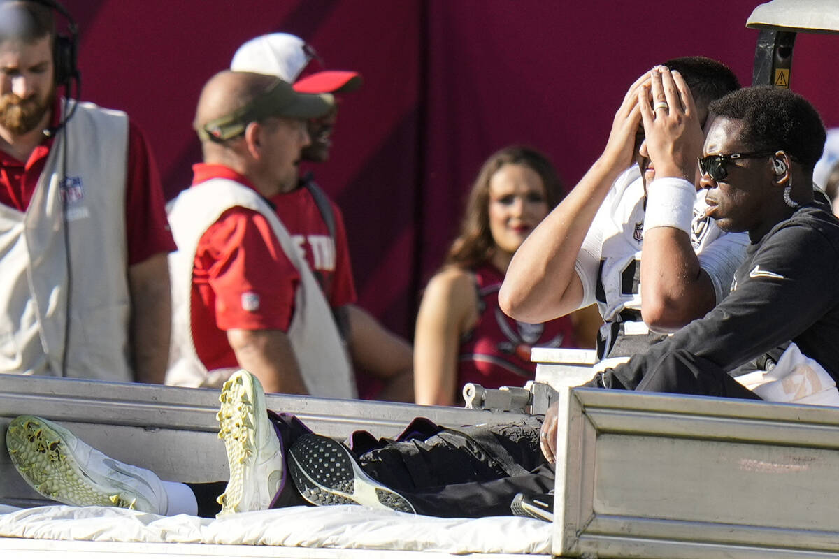 Las Vegas Raiders quarterback Aidan O'Connell (12) is taken off the field after an injury again ...