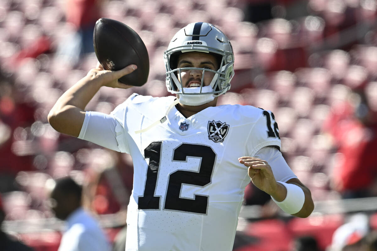 Las Vegas Raiders quarterback Aidan O'Connell (12) warms up before an NFL football game between ...