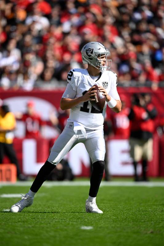 Las Vegas Raiders quarterback Aidan O'Connell (12) looks for a receiver against the Tampa Bay B ...