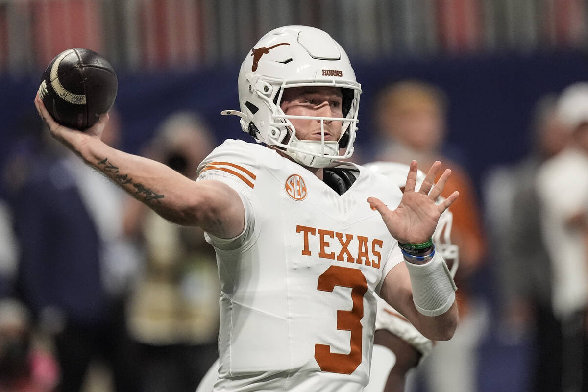 Texas quarterback Quinn Ewers (3) works in the pocket against Georgia during the first half of ...