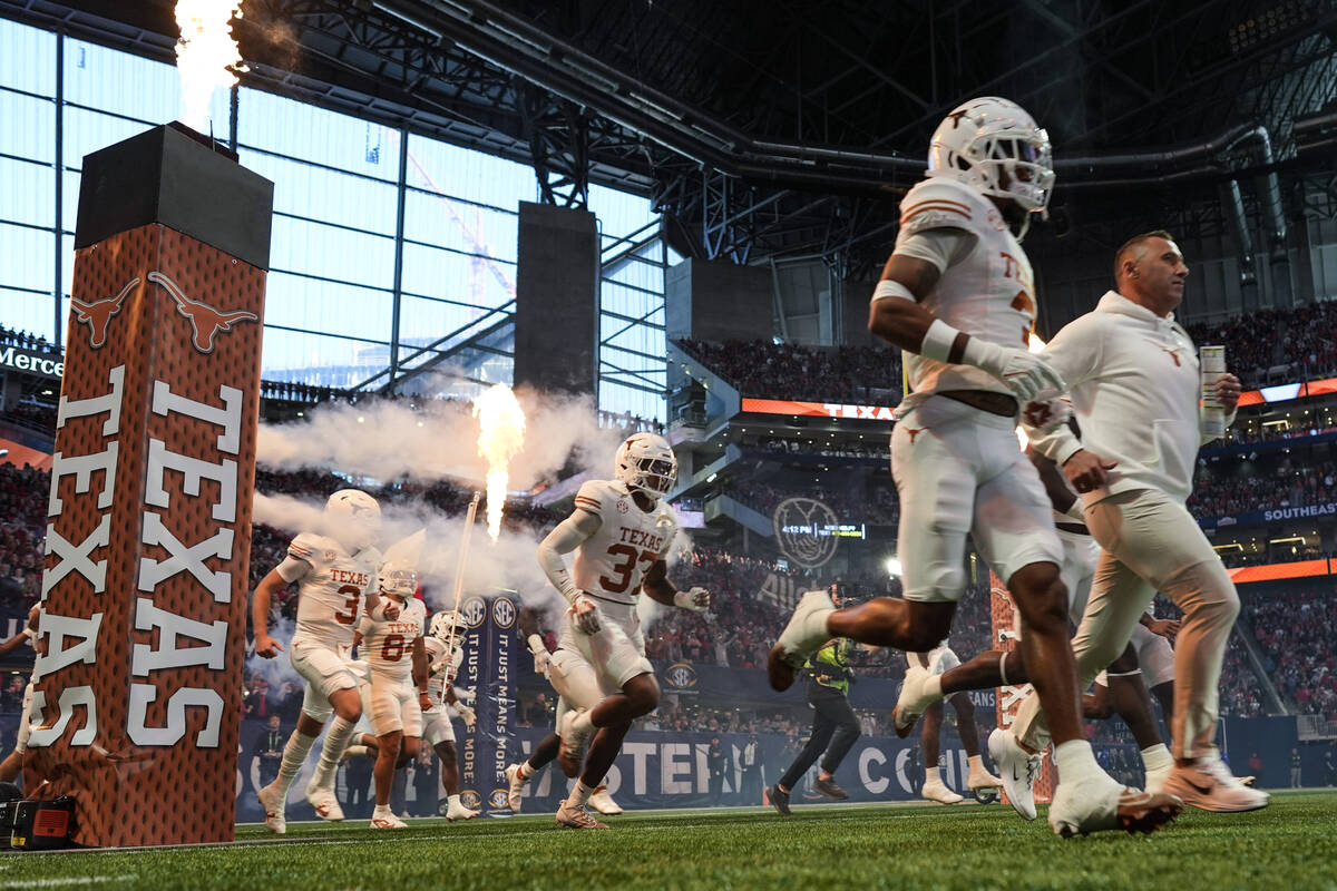 Texas players enter the field before the Southeastern Conference championship NCAA college foot ...