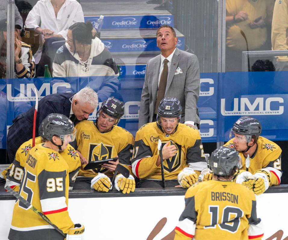 Vegas Golden Knights Head Coach Bruce Cassidy watches the big screen during the NHL hockey game ...