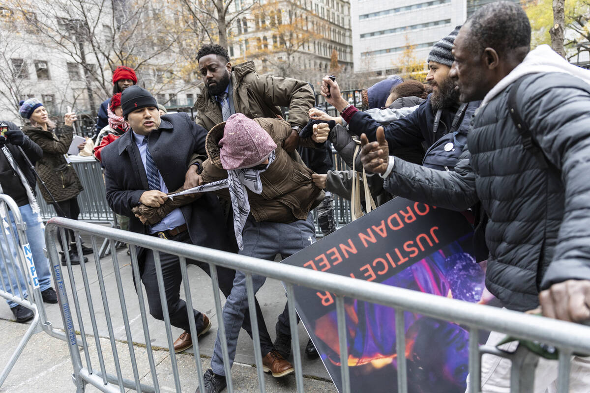 A person protesting the not guilty verdict of Daniel Penny is arrested by police outside the cr ...