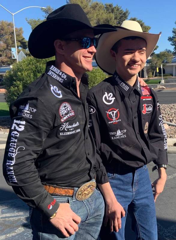 World champion bareback rider Tim O'Connell, left, and 16-year-old Angelo Mayorga share a momen ...