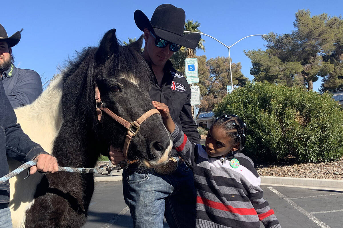 Three-time world bareback bronc champion Tim O'Connell helps 5-year-old King James acclimate to ...