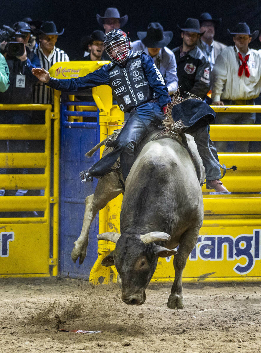 Bull Riding contestant Josh Frost rides Bill Fick Surprised to a winning score during National ...