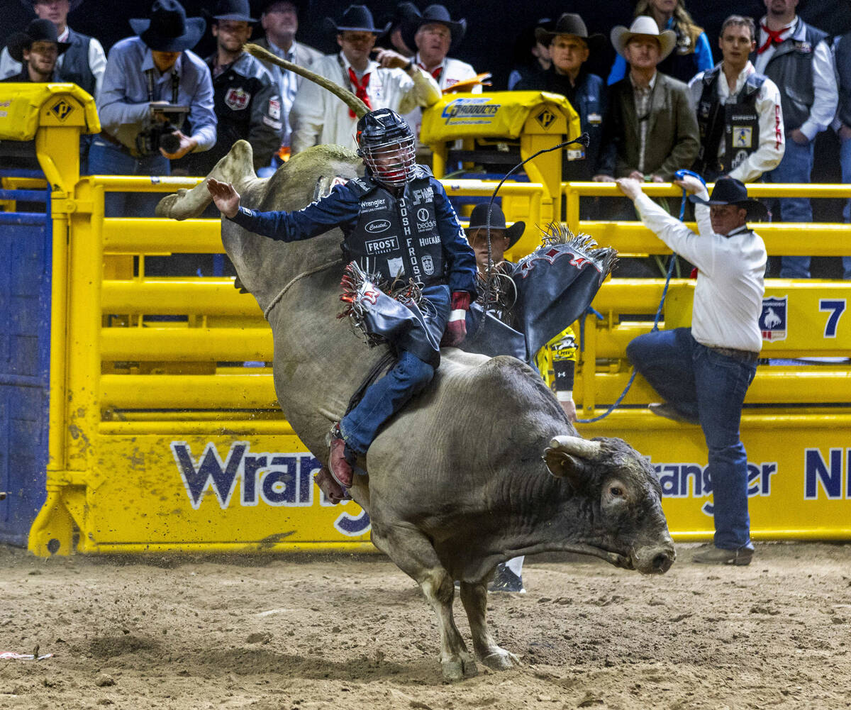 Bull Riding contestant Josh Frost rides Bill Fick Surprised to a winning score during National ...