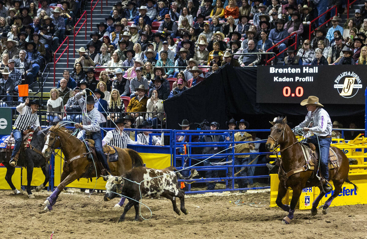 Team Roping contestants Header Brenten Hall, right, and Healer Kaden Profili works to top their ...