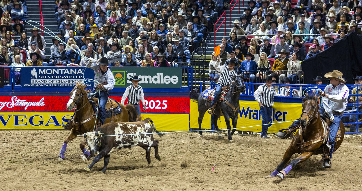 Team Roping contestants Header Brenten Hall, right, and Healer Kaden Profili works to top their ...