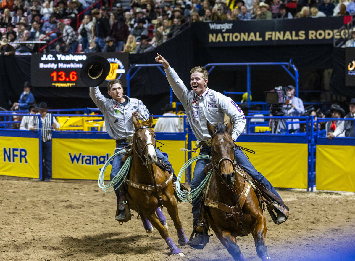 Team Roping contestants Header Brenten Hall, right, and Healer Kaden Profili celebrate their wi ...