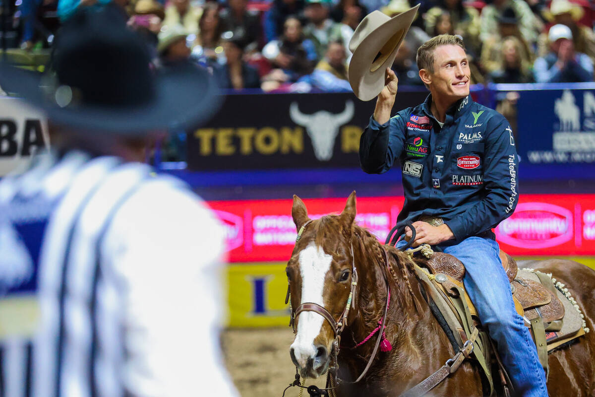 Tie-down roper Tuf Cooper gestures to the crowd during round three of the National Finals Rodeo ...