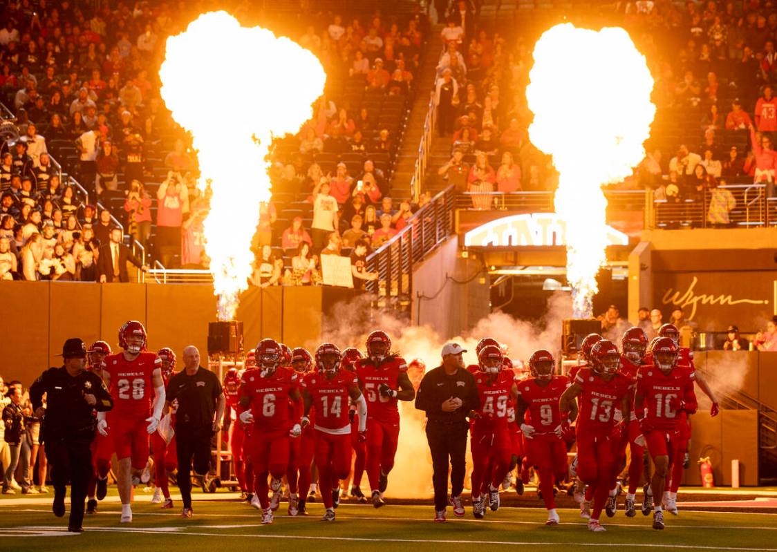 UNLV enters the field before the 50th "Battle for the Fremont Cannon" NCAA college football gam ...