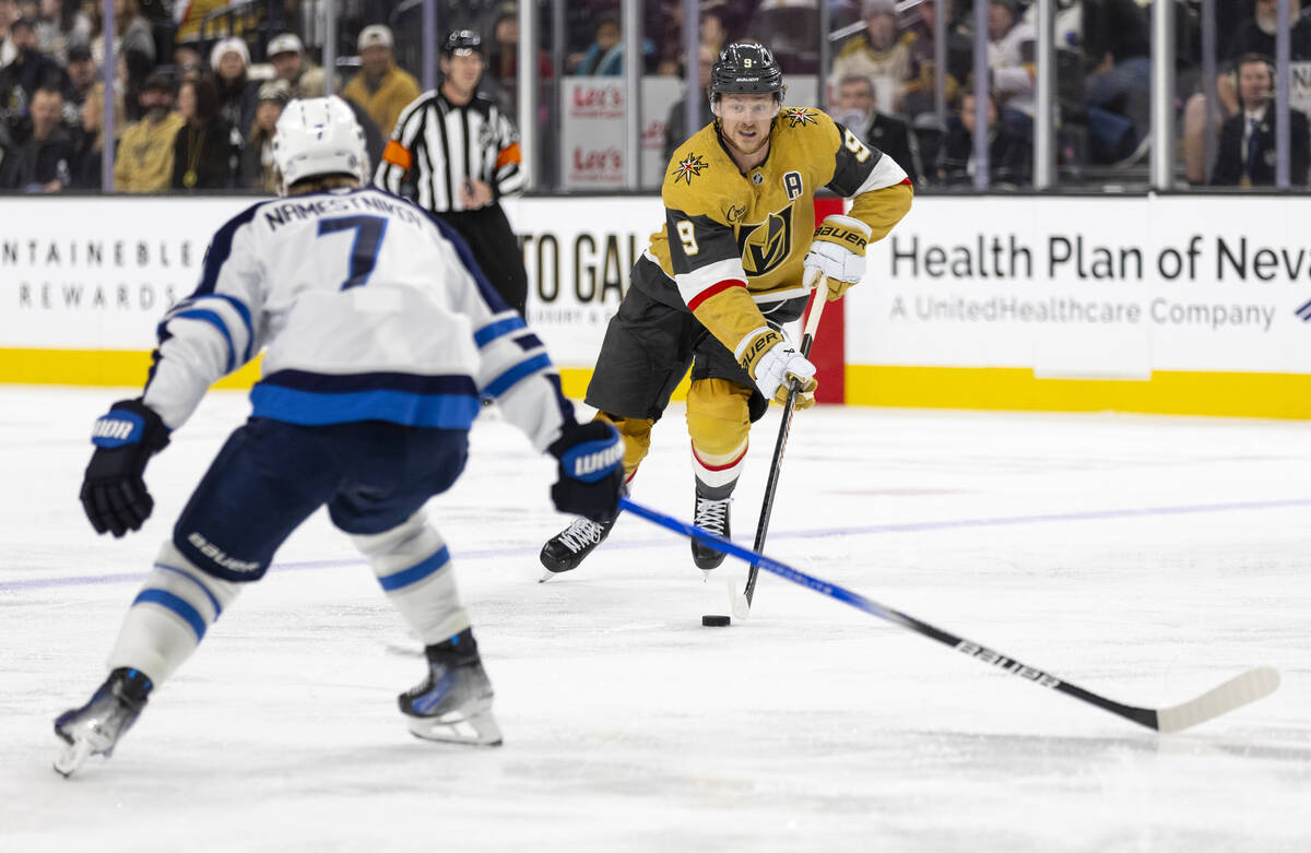 Golden Knights center Jack Eichel (9) controls the puck during the NHL hockey game against the ...