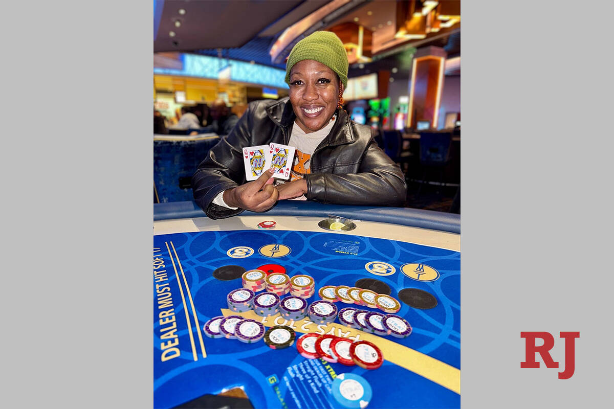 Las Vegas resident Ojebo Walker with her winning hand that paid her $111,621.45 on Monday, Dec. ...