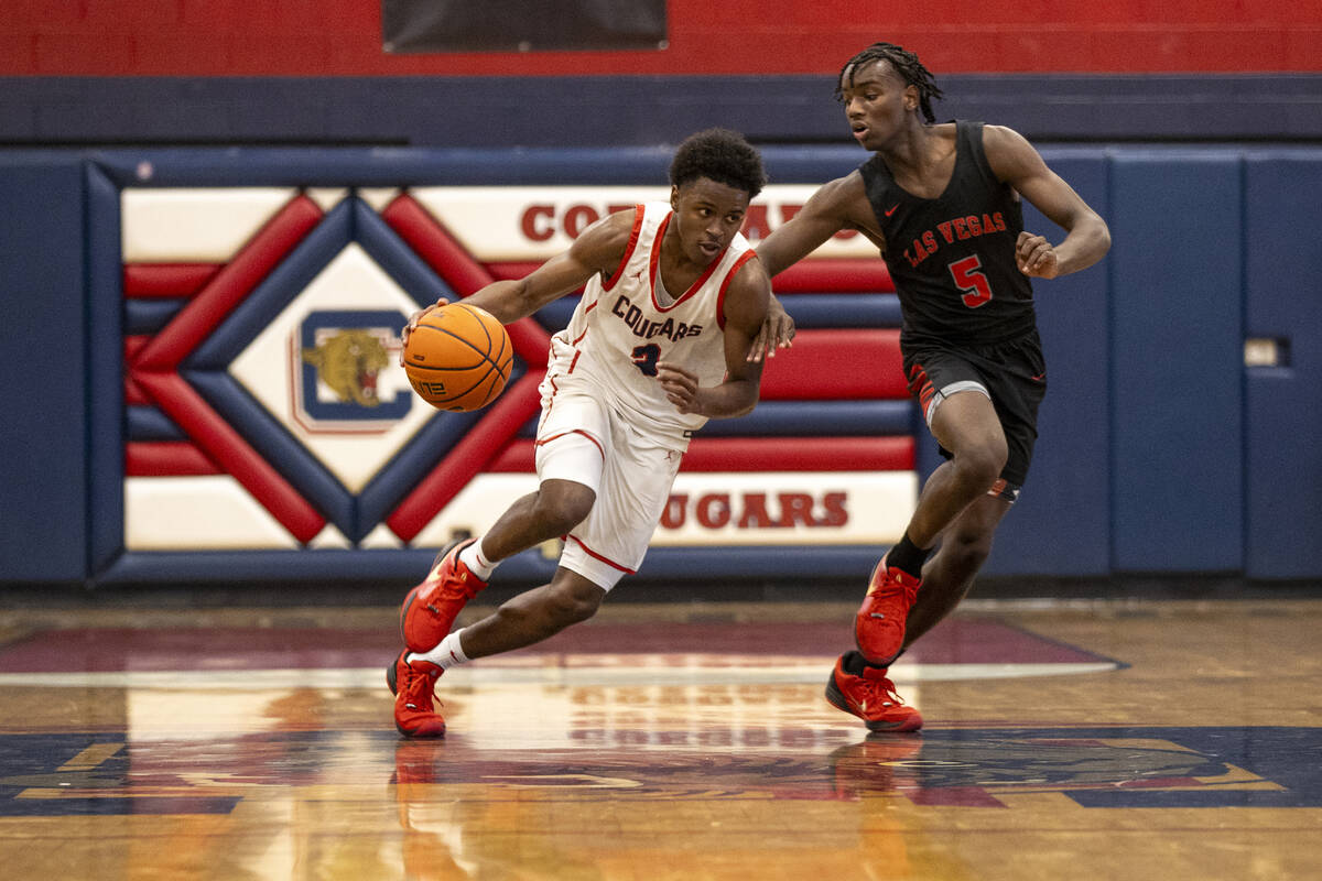 Coronado senior Jalen St. Clair (3) dribbles the ball past Las Vegas junior Jakhai Jones (5) du ...