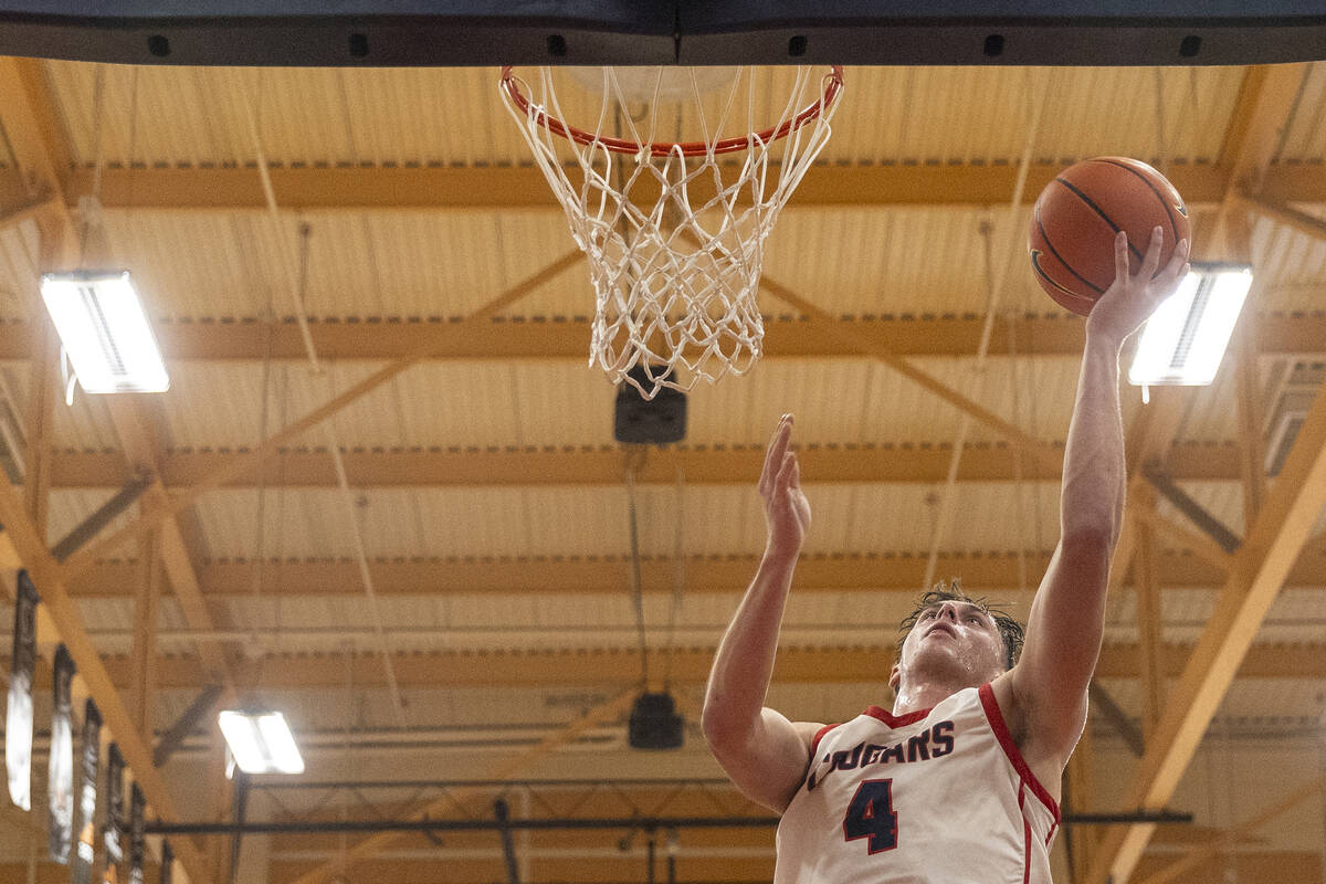 Coronado senior JJ Buchanan (4) attempts a layup during the high school basketball game against ...