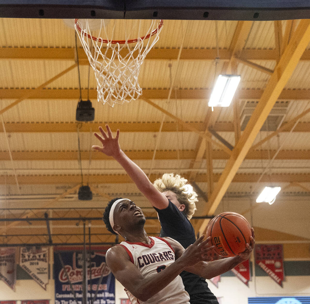 Coronado junior Jonny Collins, left, attempts a layup during the high school basketball game ag ...