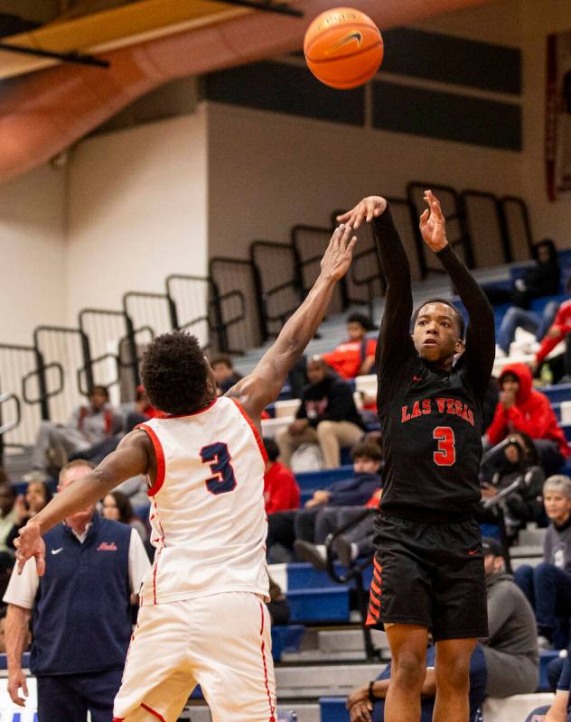 Las Vegas senior Tayshaun Jackson (3) attempts a shot during the high school basketball game ag ...