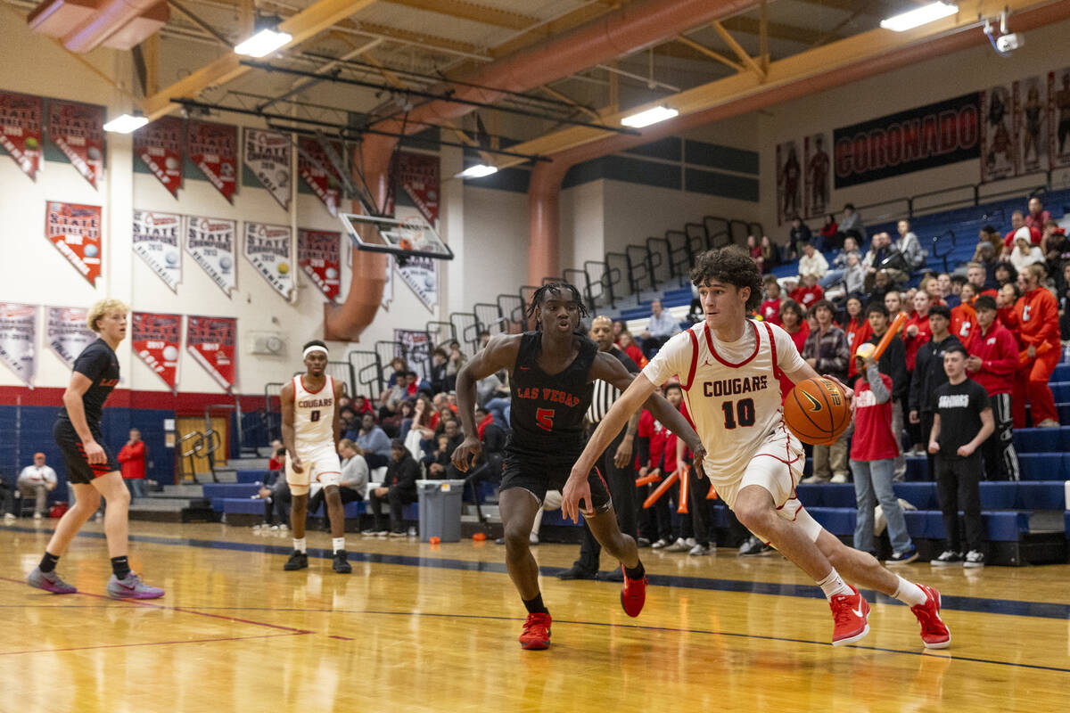 Coronado senior Mason Abittan (10) dribbles around Las Vegas junior Jakhai Jones (5) during the ...