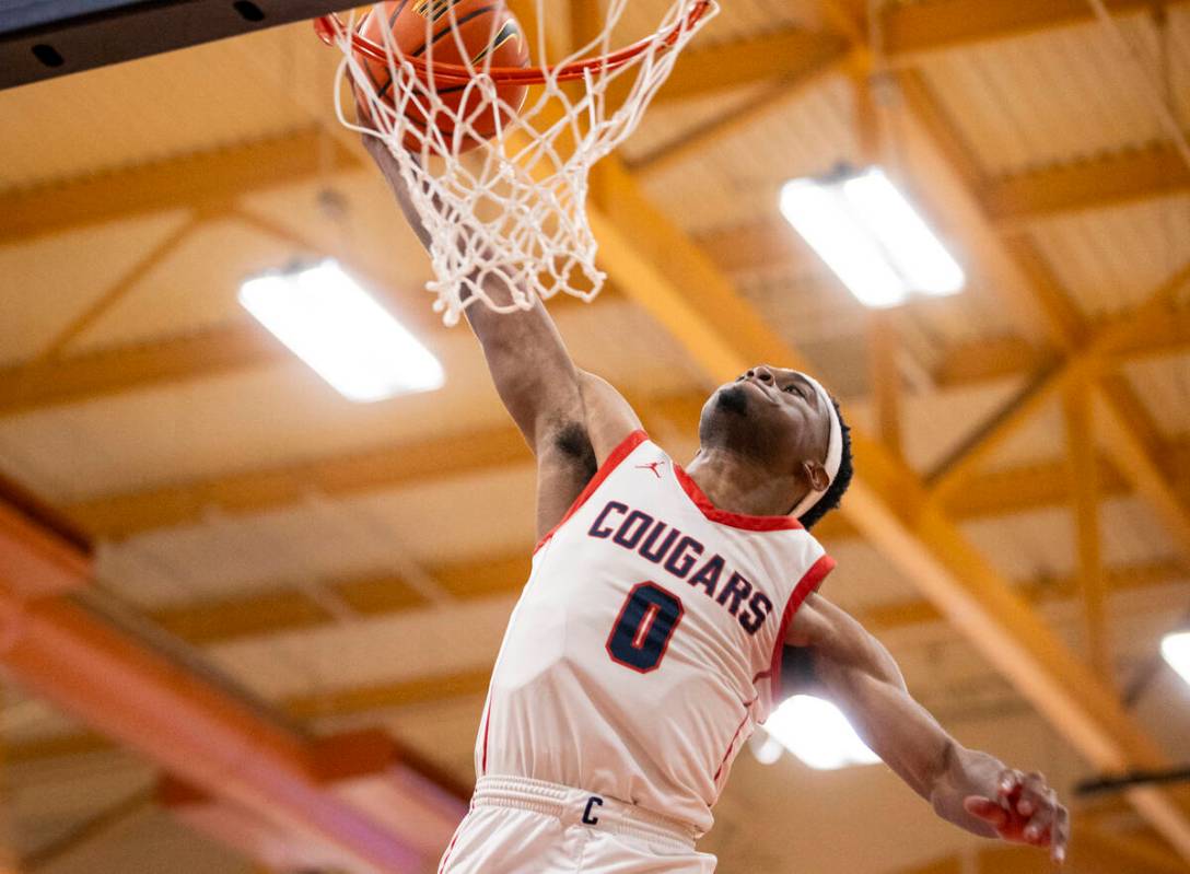 Coronado junior Jonny Collins (0) dunks the ball during the high school basketball game against ...