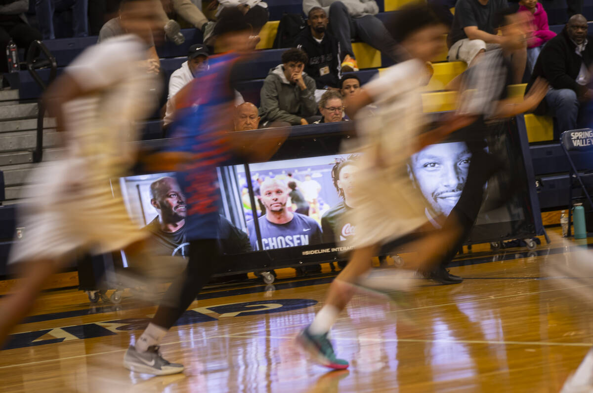 Images of community figure and basketball coach Abdul Adem are displayed before a basketball ga ...