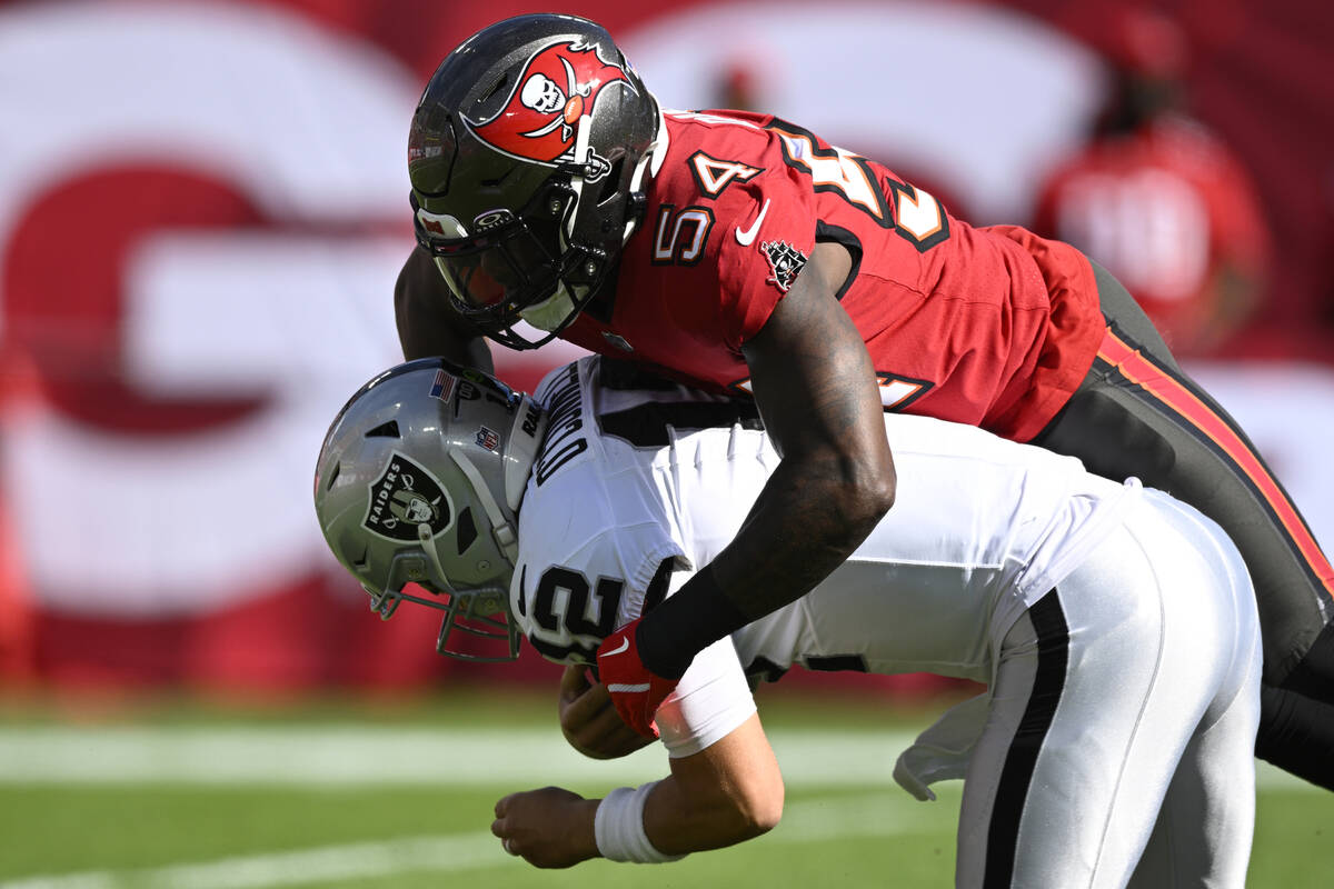 Las Vegas Raiders quarterback Aidan O'Connell (12) is sacked by Tampa Bay Buccaneers linebacker ...