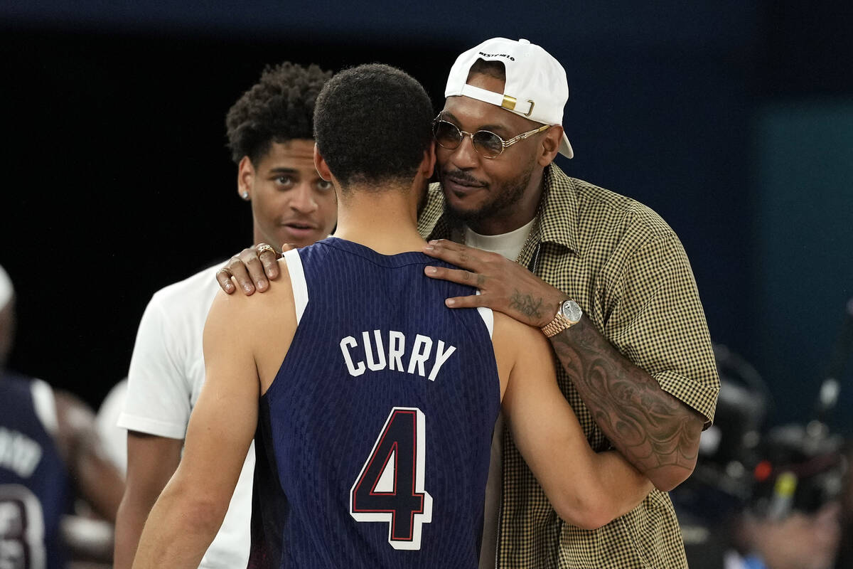 United States' Stephen Curry, center, greets Kiyan Anthony, left, and Carmelo Anthony, after th ...