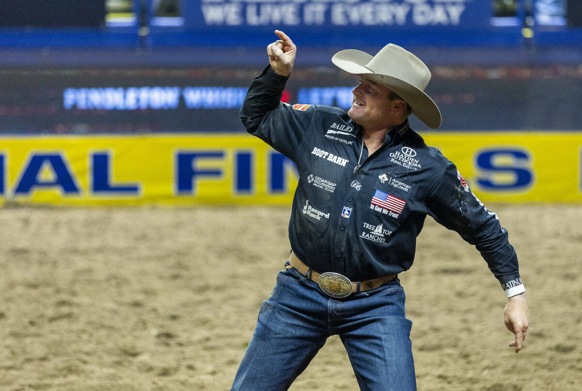 Steer Wrestling contestant Dakota Eldridge celebrates taking his steer down in winning time dur ...