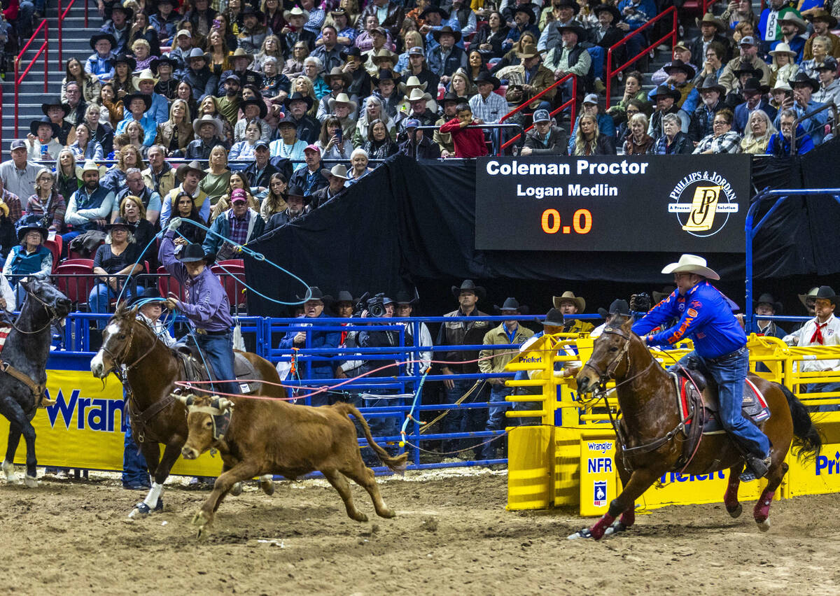 Team Roping Header Coleman Proctor and Heeler Logan Medlin bear down to rope their calf for a w ...