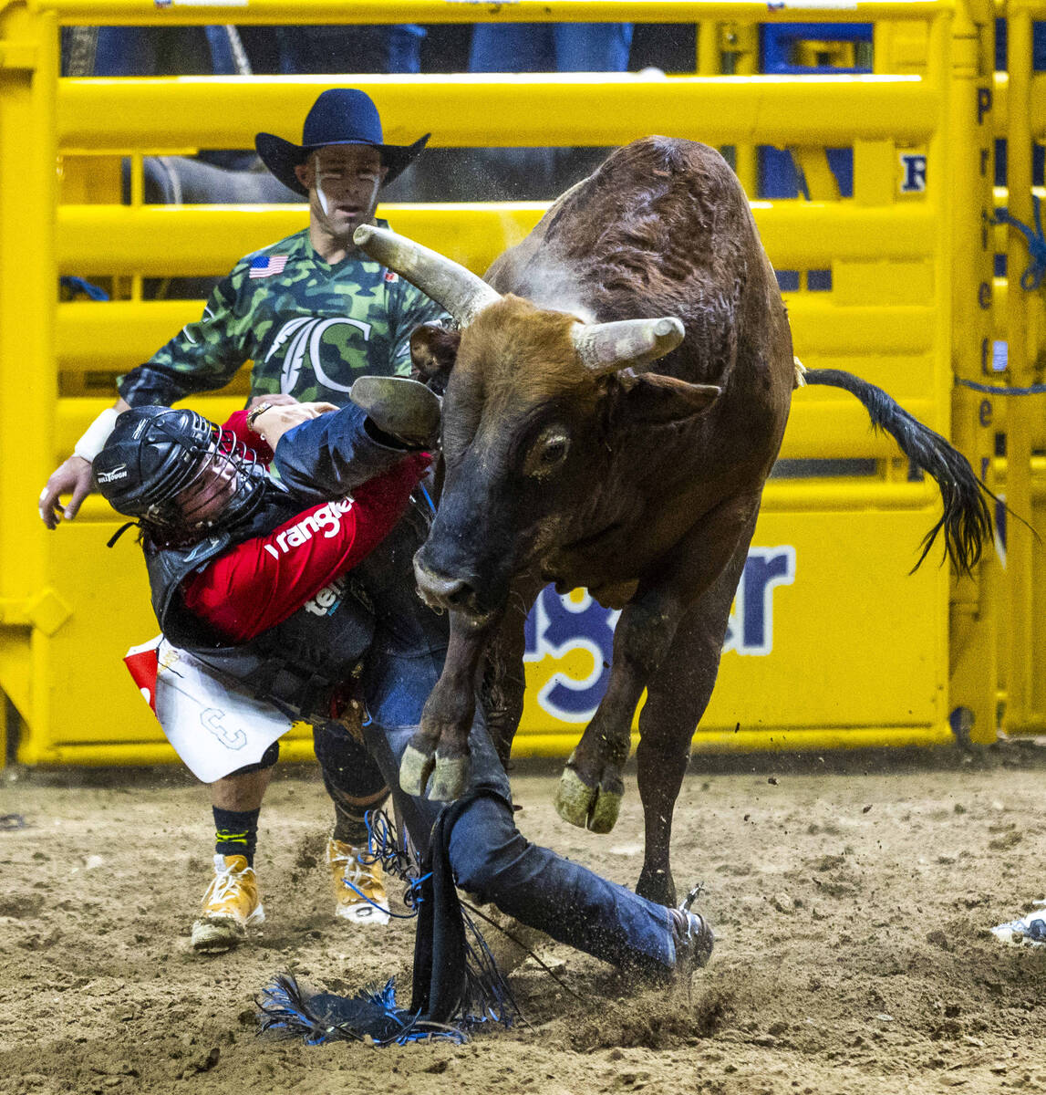 Bull Riding contestant Wacey Schalla gets his boot hung up over his cinched hand while riding D ...