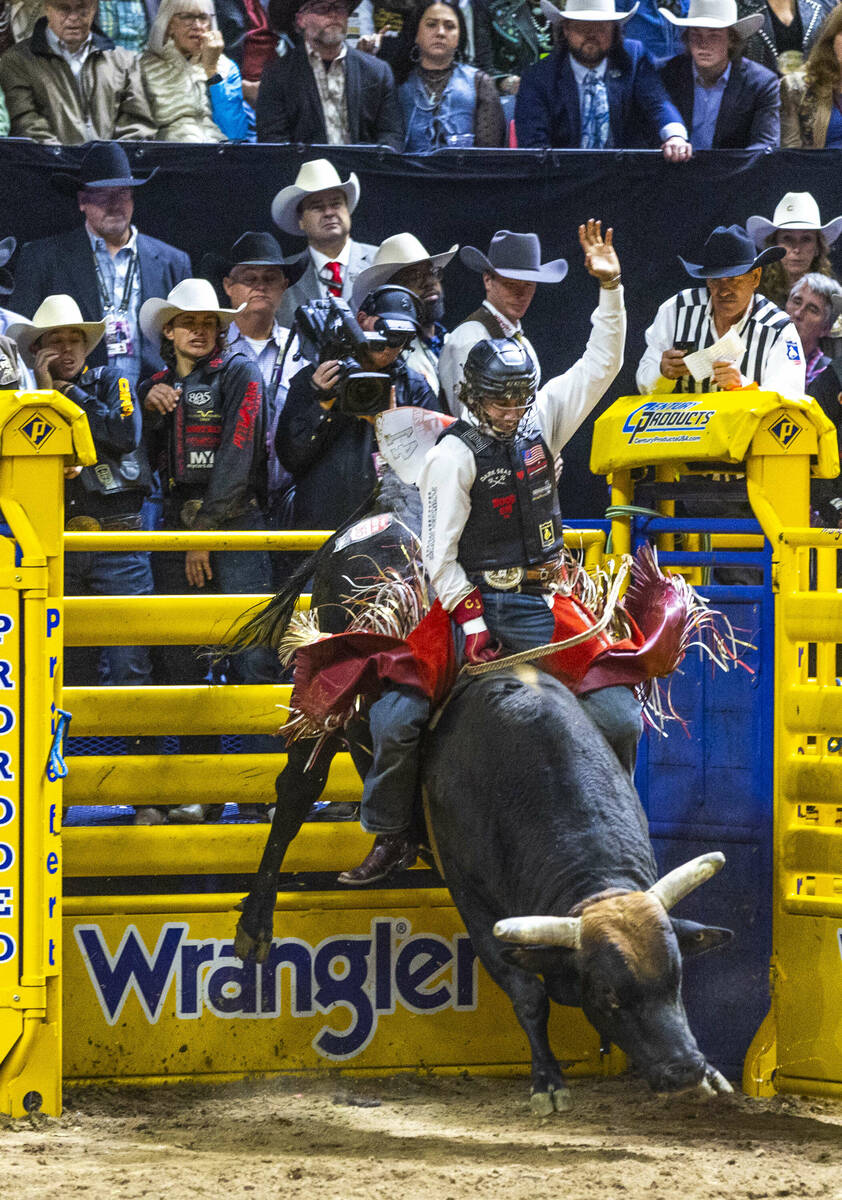 Bull Riding contestant Cooper James rides Midnight Rider to a winning score during National Fin ...