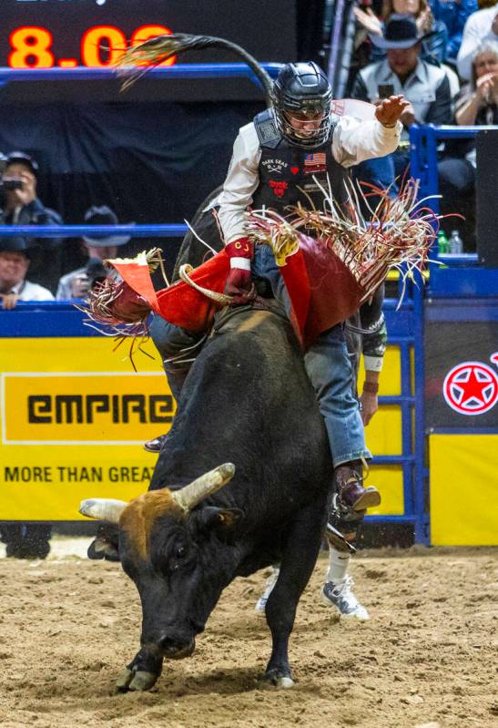 Bull Riding contestant Cooper James rides Midnight Rider to a winning score during National Fin ...