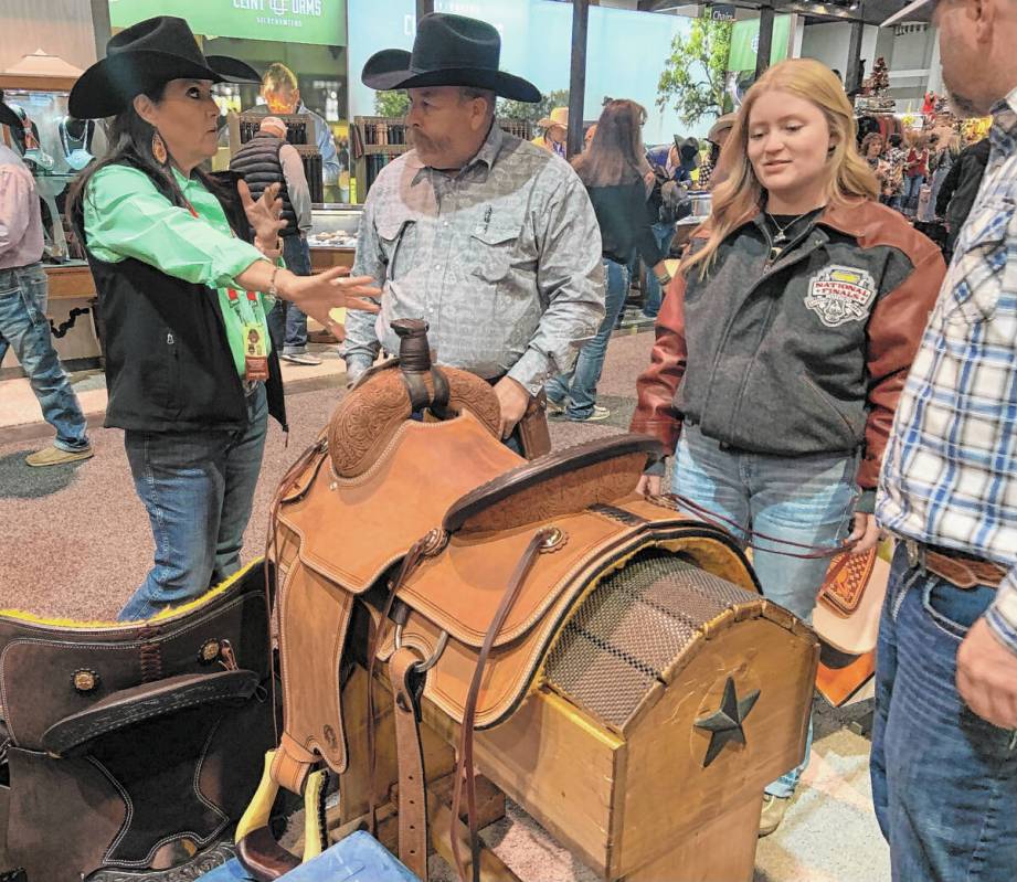 Circle Y Saddles' Jill Hollomon, left, helps Tony Ericksen, Brenna Williams and Colton Williams ...