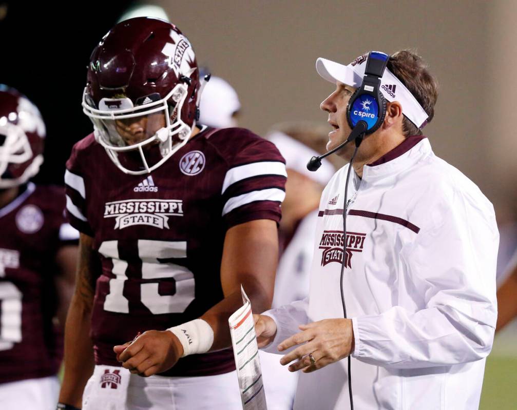 Mississippi State quarterback Dak Prescott (15) listens to his coach Dan Mullen during the firs ...