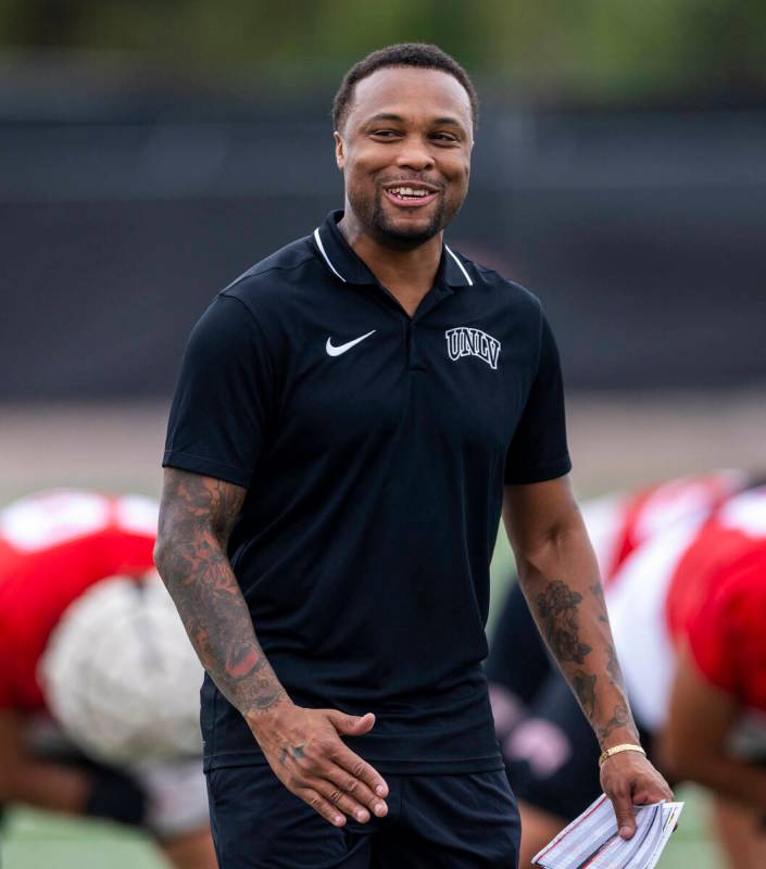 UNLV Offensive Coordinator/Quarterbacks Brennan Marion talks with players during the first day ...