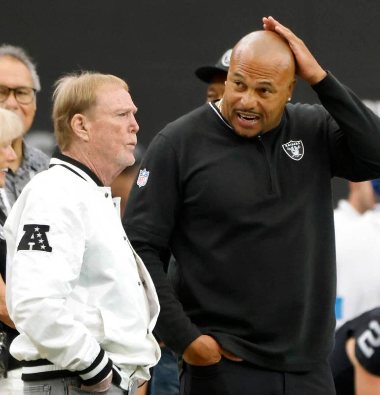 Raiders owner Mark Davis, left, and head coach Antonio Pierce chat before an NFL game against P ...