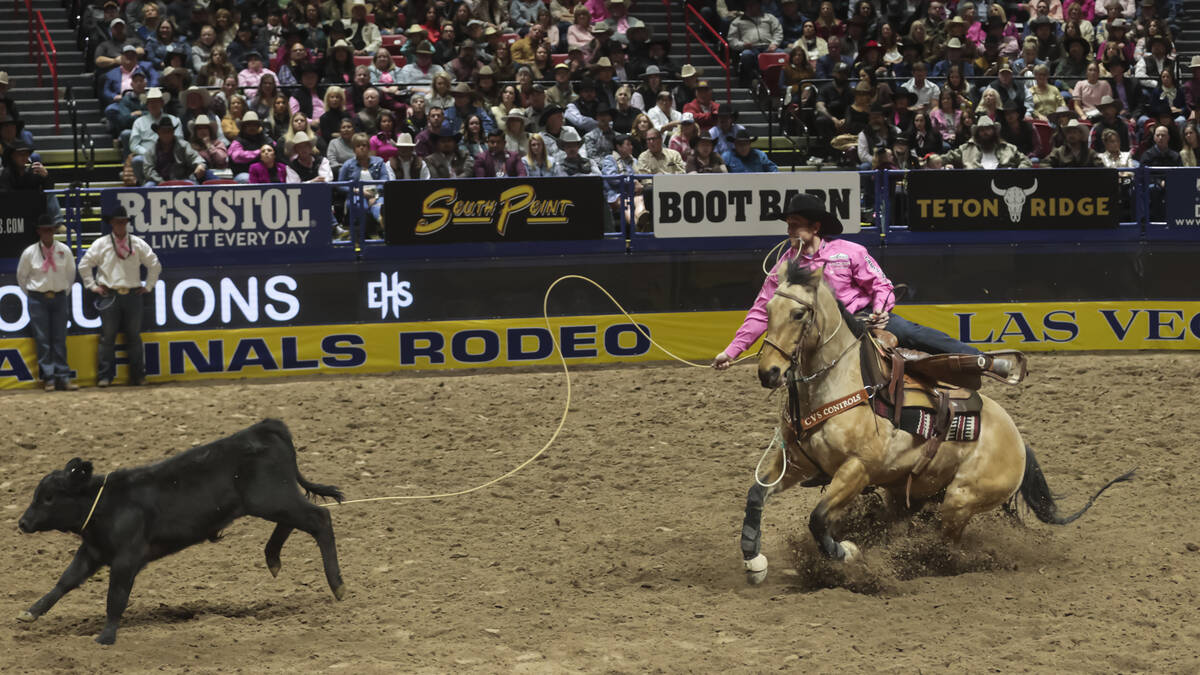 Joel Harris competes in tie-down roping during the fifth go-round of the National Finals Rodeo ...